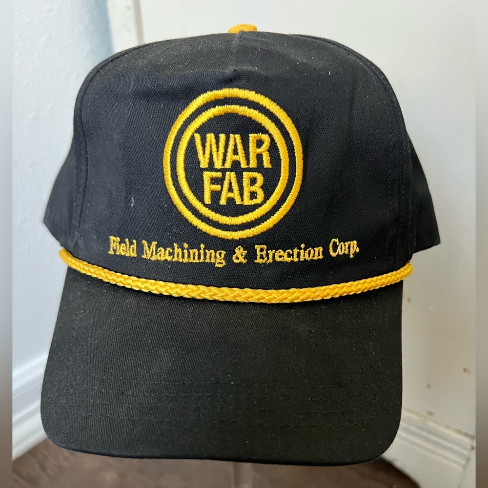 Vintage black with gold WAR FAB hat.  Gold rope.  Adjustable back.